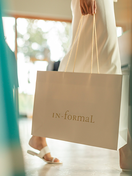 A woman walks across the frame carrying a shopping bag from In Formal, one of the shopping outlets at the D Maris Bay resort available to guests.  