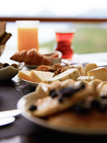 A selection of pastries and cheeses on a table, as part of a continental breakfast spread served to guests at D Maris Bay resort.