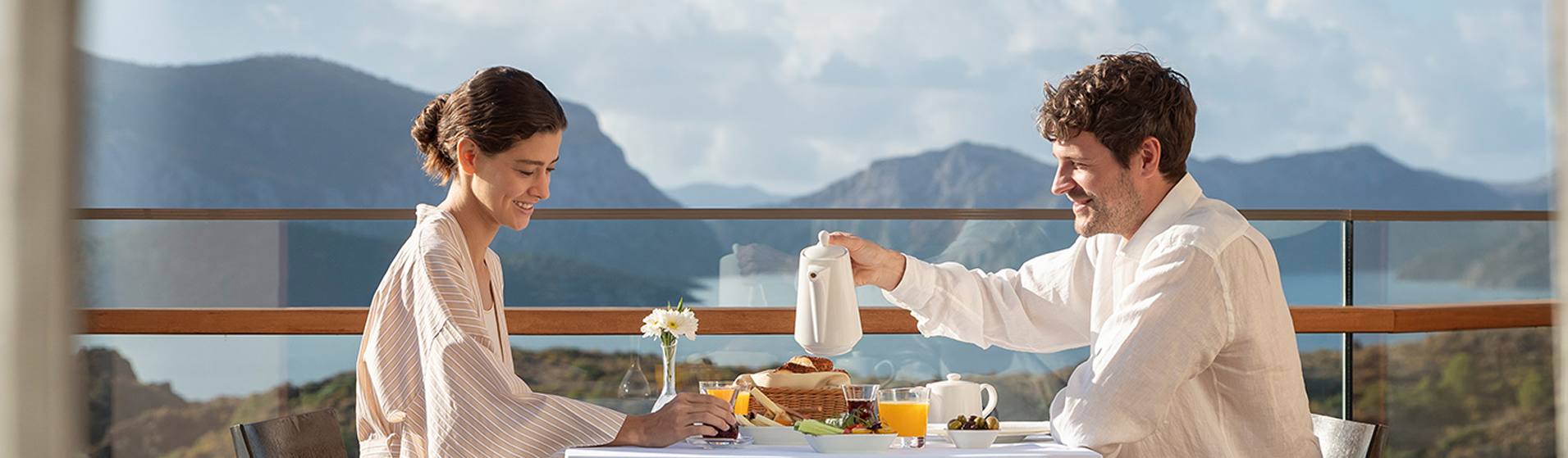A couple enjoy an al fresco breakfast on the balcony of their room at the D Maris Bay resort.